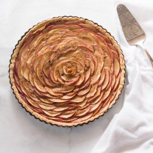apple rose tart with dulce de leche kitchen towel and spatula