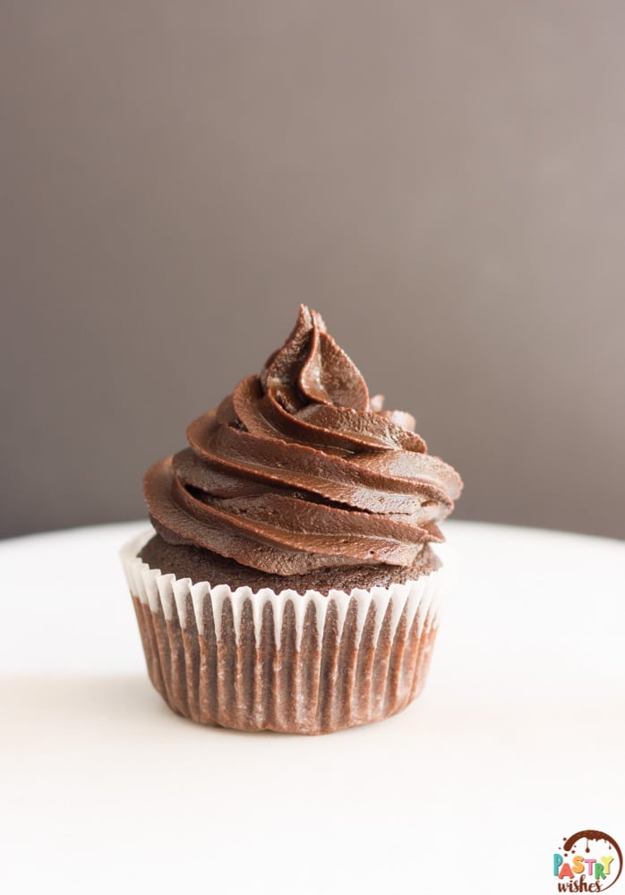 classic chocolate cupcake with dark chocolate frosting in a white wrapper