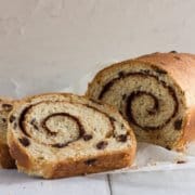swirled cinnamon raisin bread with two slices and a loaf