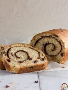 swirled cinnamon raisin bread with two slices and a loaf