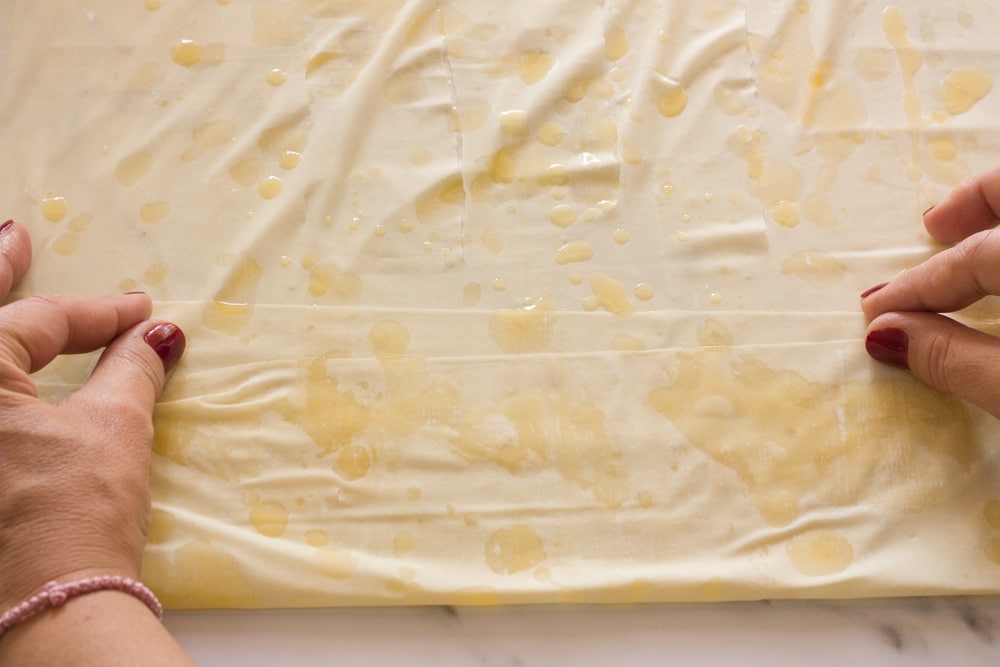 two sheets of phyllo dough buttered and bottom folded over