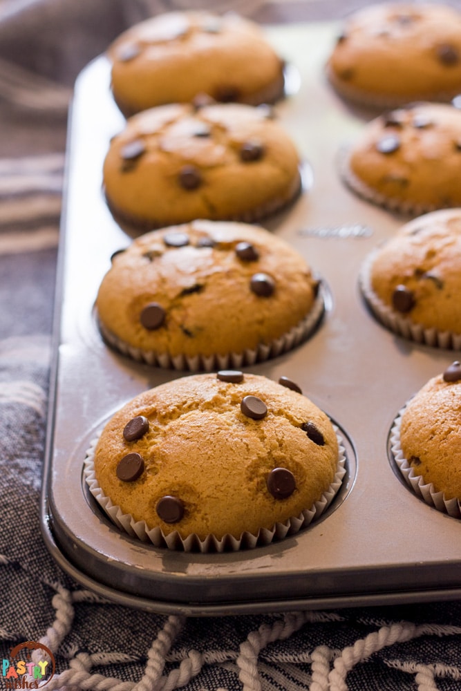 Vegan Chocolate Chip Muffins in a pan on a kitchen towel