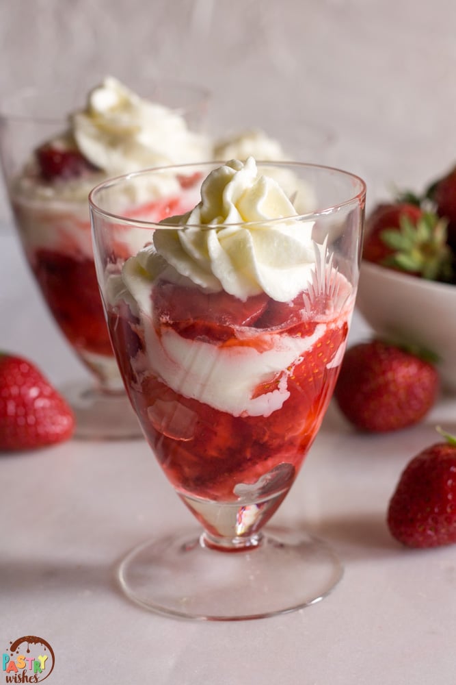 strawberry cups with a bowl of strawberries in the background