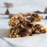 A close up of chocolate chunk cookies with melted chocolate pieces.