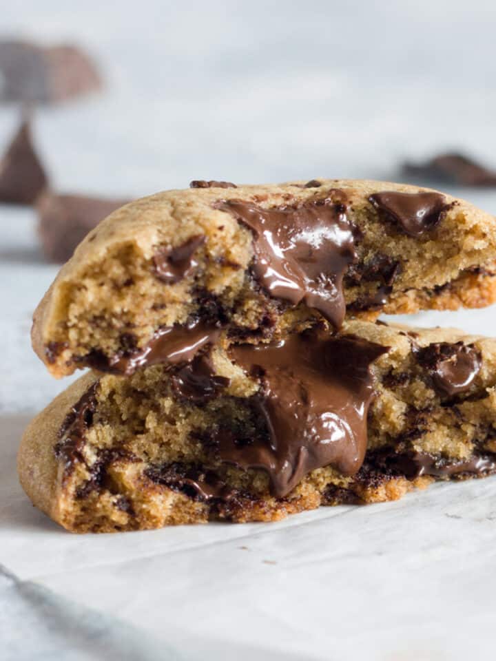 A close up of chocolate chunk cookies with melted chocolate pieces.