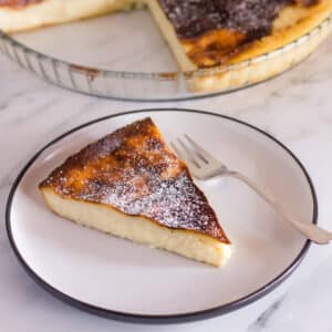 galatopita greek milk pie slice on a plate and pie dish in background