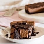 A slice of eggless chocolate cheesecake on a plate with a fork.