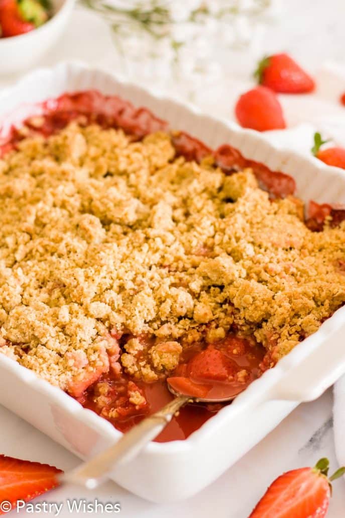 strawberry and apple crumble in a white baking dish