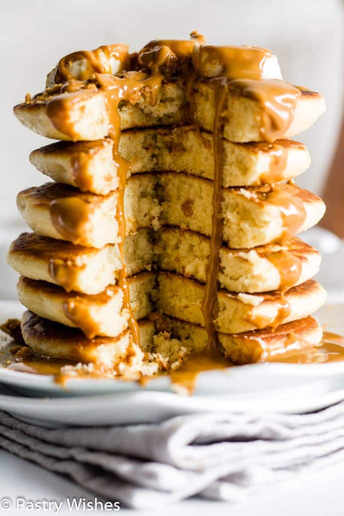 a cut out stack of pancakes with melted biscoff spread and bananas