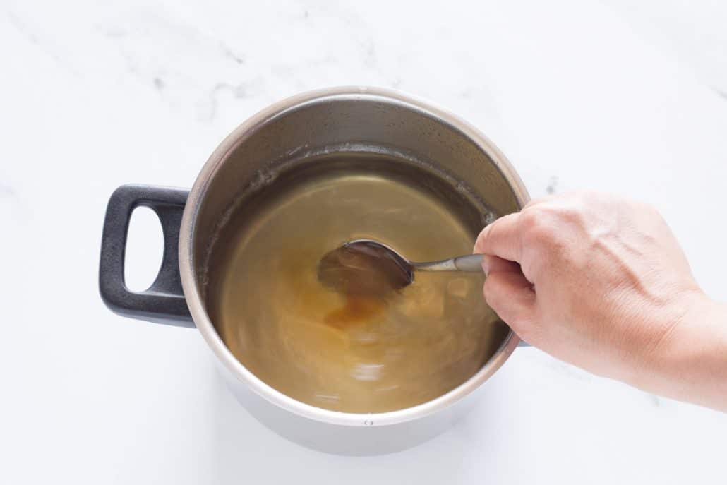 stirring honey into syrup for ekmek kataifi
