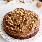 Chocolate walnut cake with fudge frosting and walnuts.
