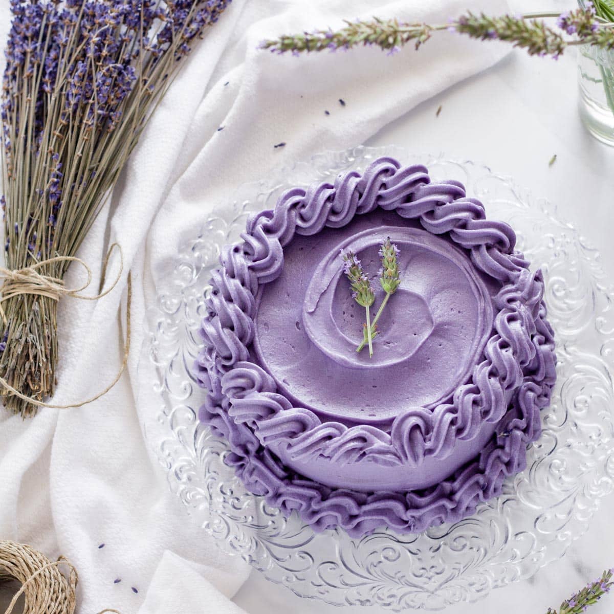 earl grey lavender cake on a white surface with lavender flowers