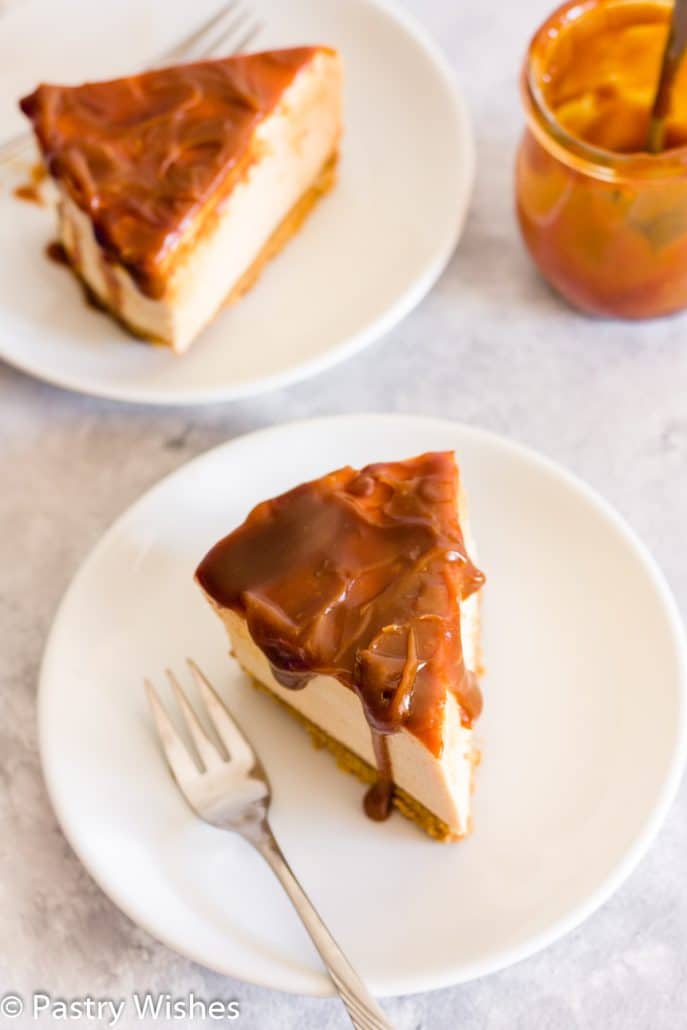 two slices of salted caramel cheesecake on white plates