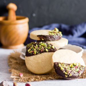 Chocolate dipped sugar cookies with chopped pistachios.