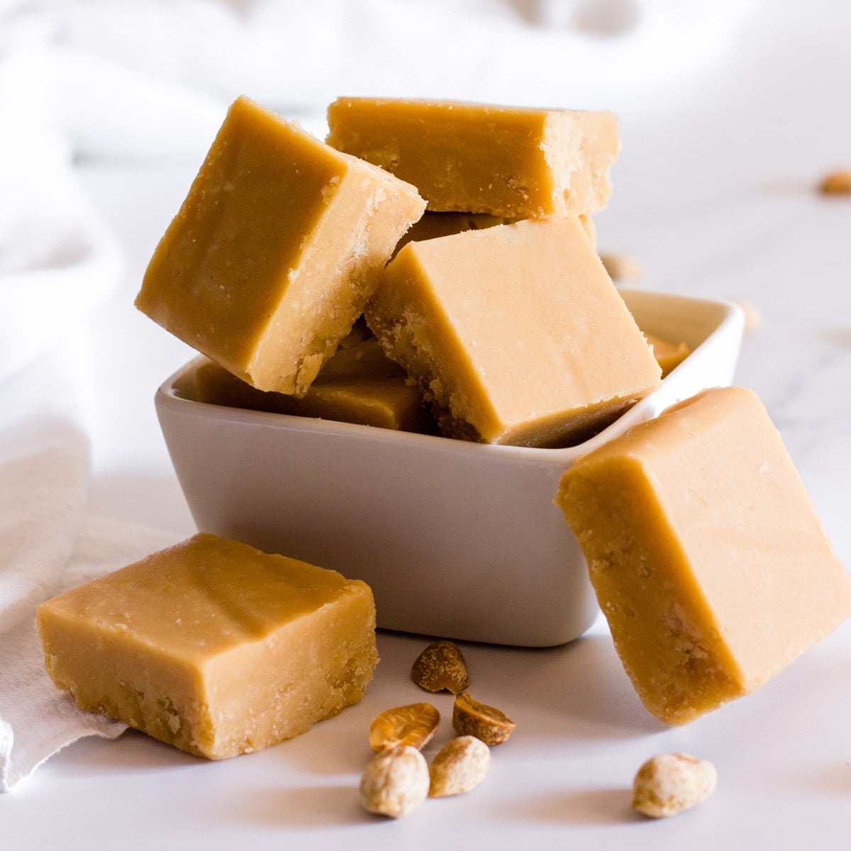 peanut butter fudge squares in a white bowl