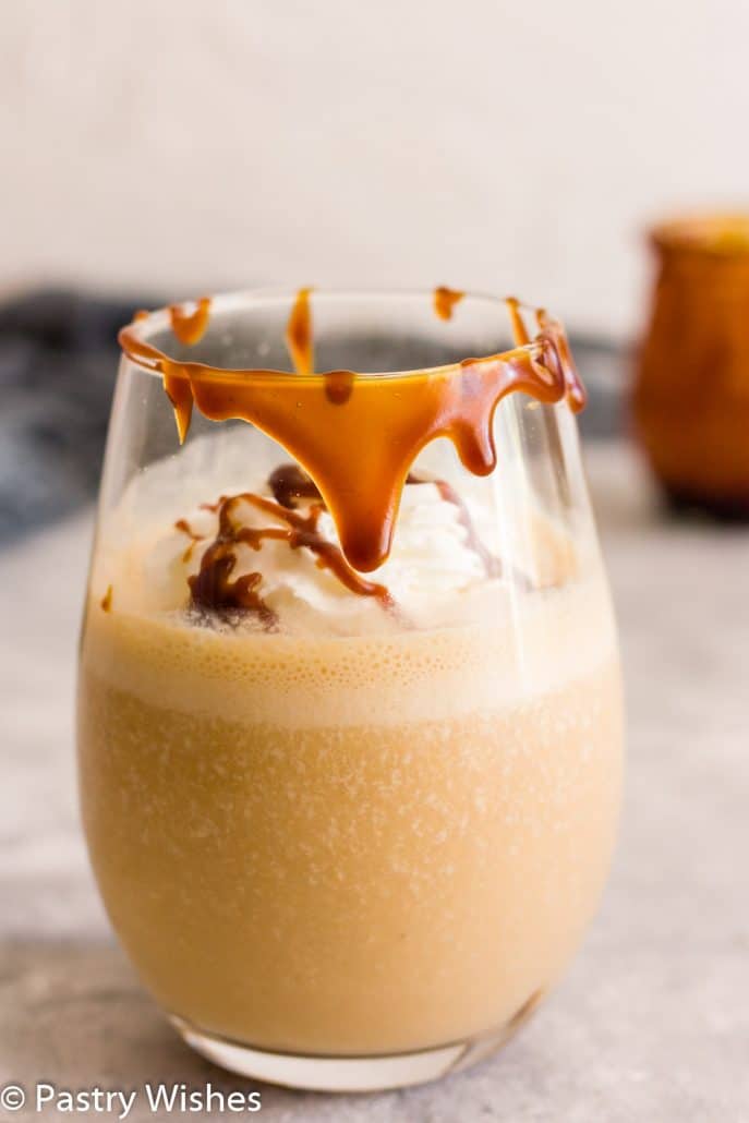 a glass of salted caramel smoothie with whipped cream