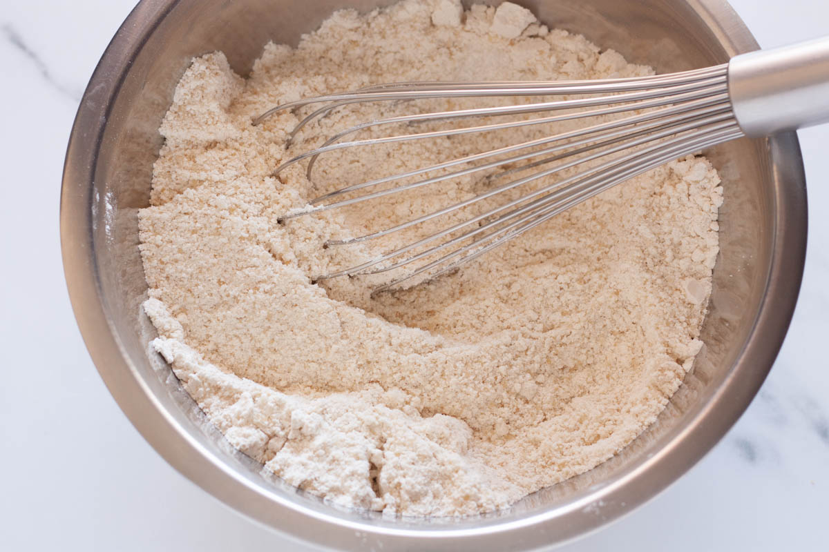 Whisking together flour, sugar, salt, baking powder and baking soda n a large bowl.