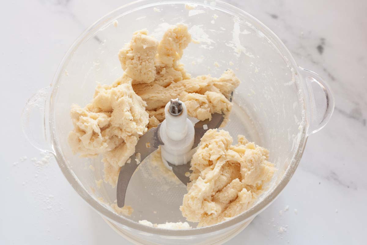Pie dough in a food processor clumped together after adding ice water.