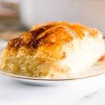A closeup of a slice of galaktoboureko on a white plate.