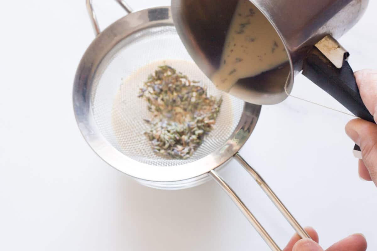 Pouring Earl Grey lavender milk through a sieve.