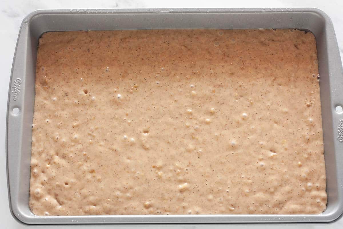 Karidopita cake batter in a rectangular baking pan before baking.
