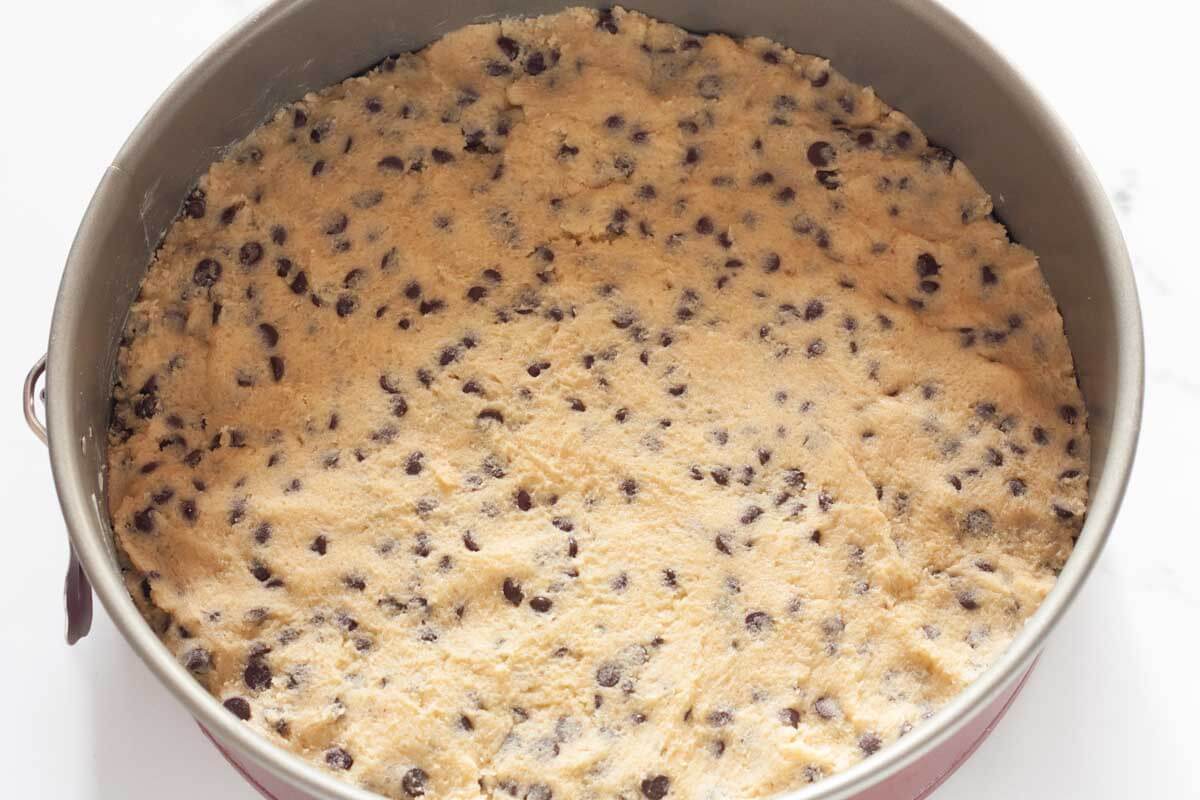 Cookie dough in a springform pan.