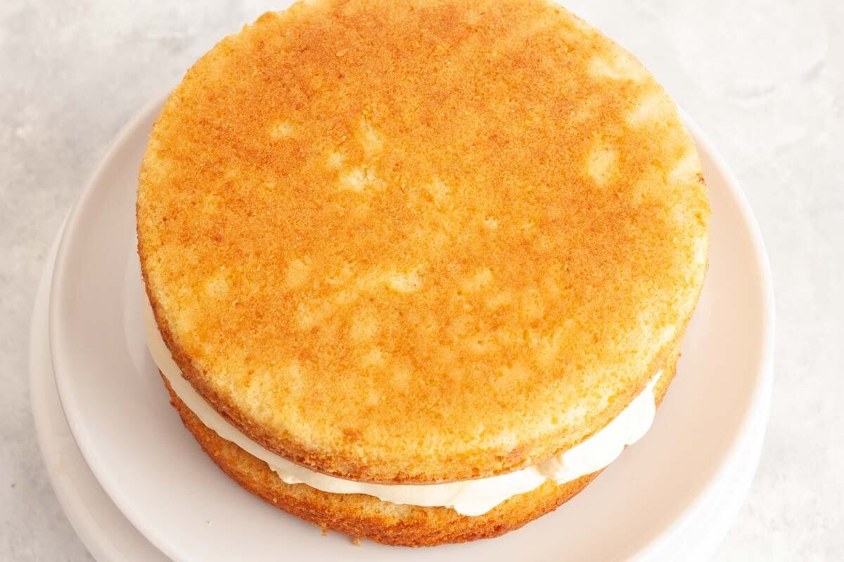 A second vanilla cake layer on top of the cake filling.