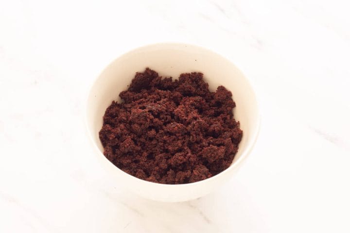 Spiced chocolate cake crumbs in a white bowl.