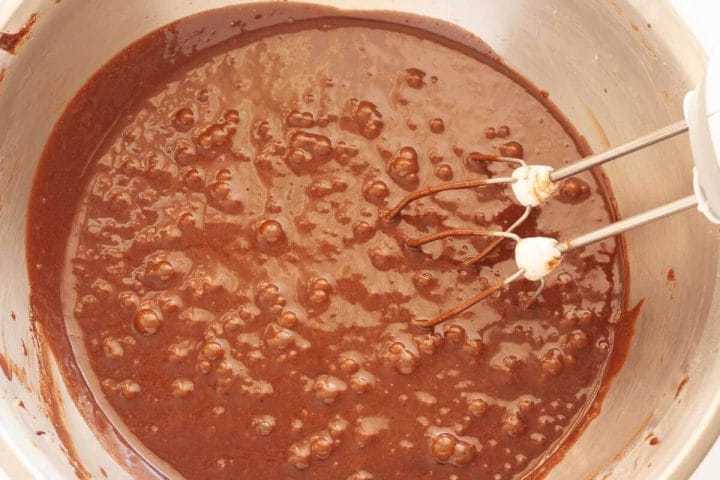 Mixing eggs and cocoa mixture with oil, buttermilk and dry ingredients.