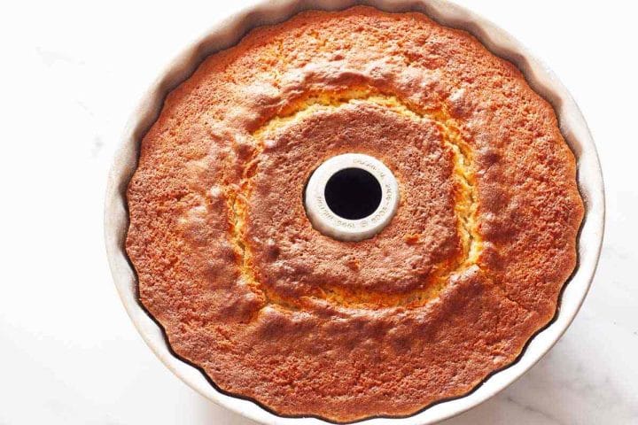 A baked lemon Bundt cake in a cake pan.