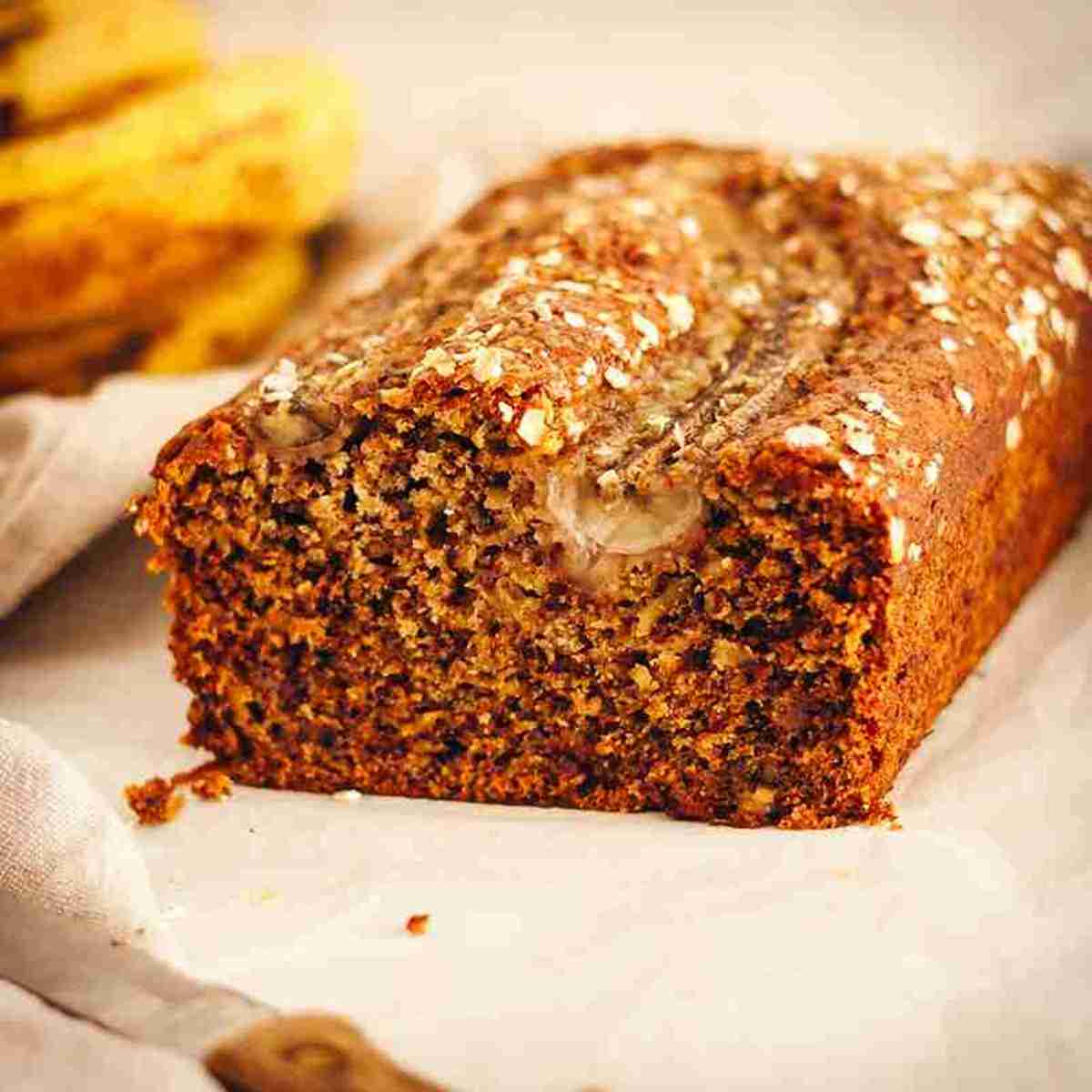 Sliced dairy-free banana bread with ripe bananas
