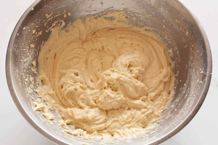 Flour mixture and buttermilk added to lemon loaf cake batter.