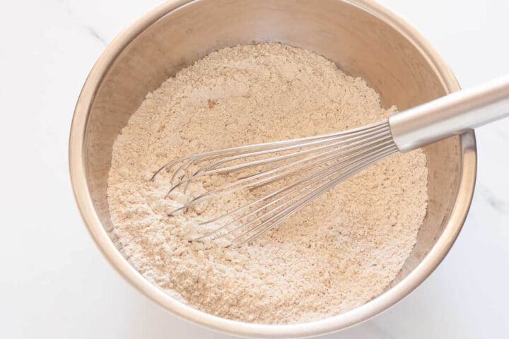 Dry ingredients for carrot Bundt cake mixed together in a bowl.