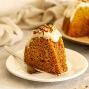 Carrot Bundt cake with cream cheese glaze served on a plate.