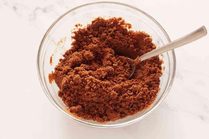 Chocolate cookie crumbs mixed with melted butter for cheesecake crust.