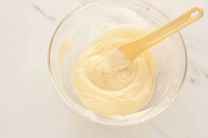 Cinnamon added to cream cheese glaze and mixed until combined.