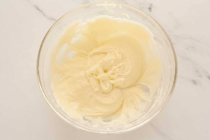 Milk added to cream cheese glaze to adjust thickness.