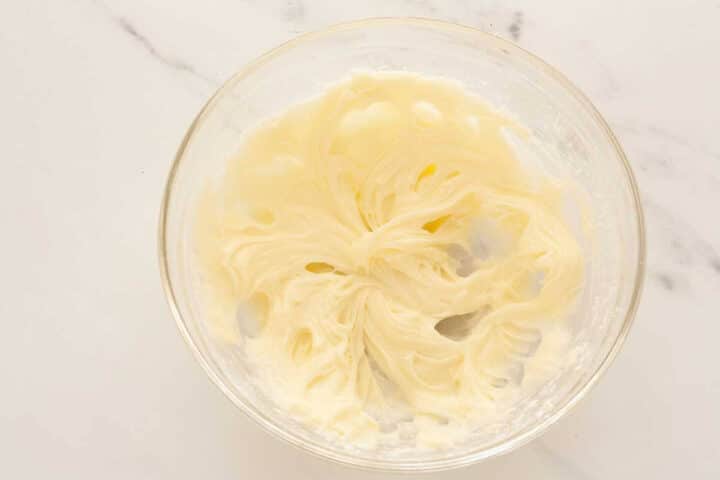Powdered sugar added to cream cheese and mixed until smooth.