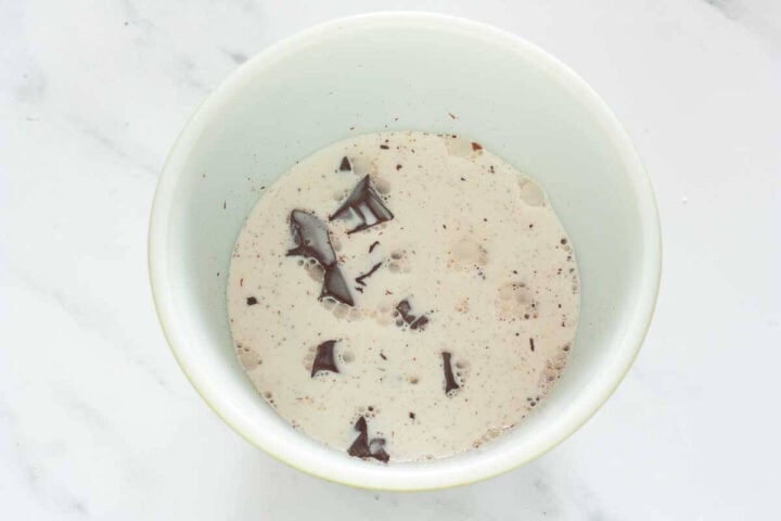 Hot cream poured over chopped chocolate to make ganache, step 2.
