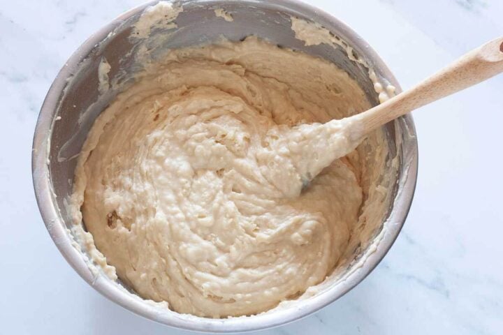 Thick Greek yogurt blueberry muffin batter in a mixing bowl.