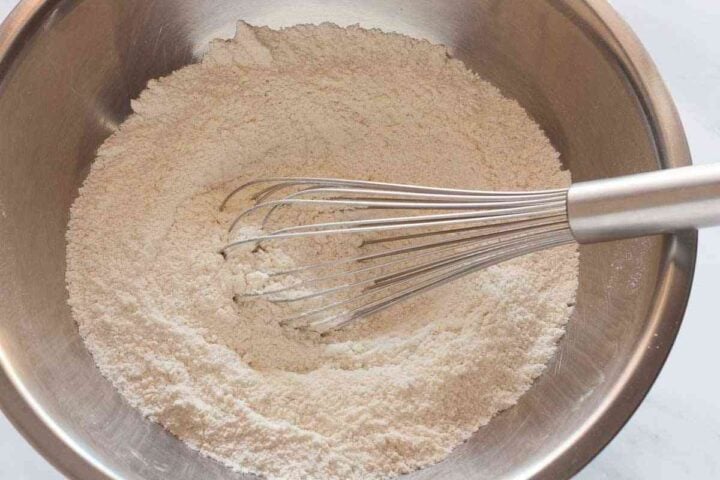 Step 2: Flour, sugar, baking powder, and salt whisked together in a mixing bowl.