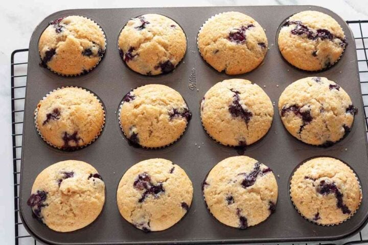 Step 7: Baked dairy-free blueberry muffins cooling in the muffin pan.