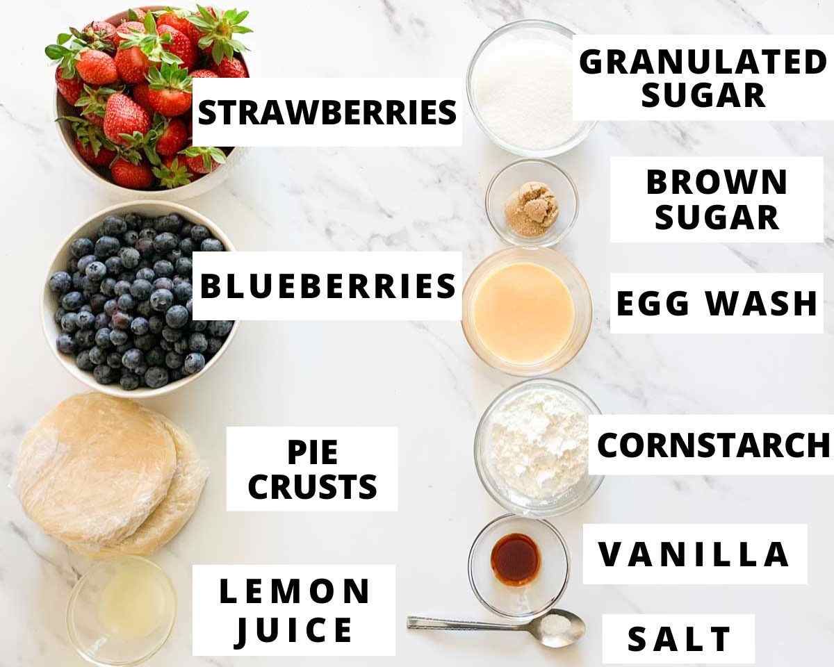 Ingredients for strawberry blueberry pie including strawberries, blueberries, pie crust, sugar, cornstarch, and lemon juice.