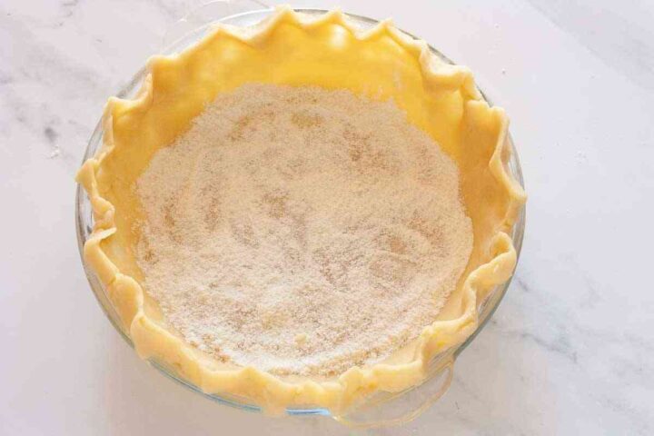 Pie crust lined in a deep-dish pie plate and sprinkled with crust dust.