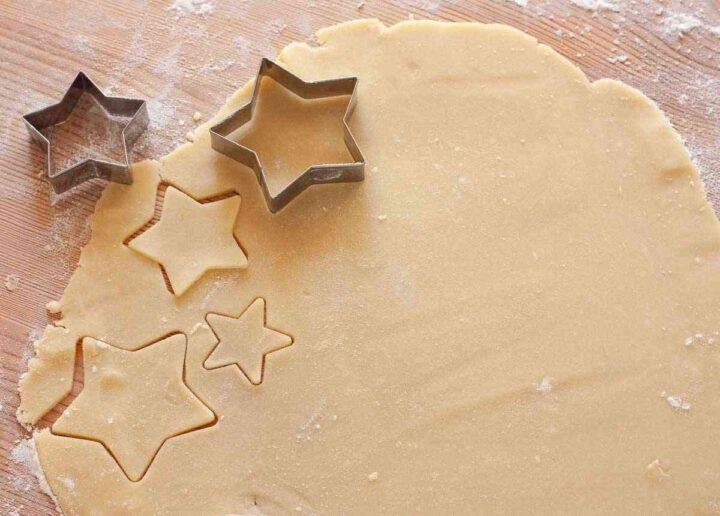 Pie dough rolled out and cut into star shapes using cookie cutters.