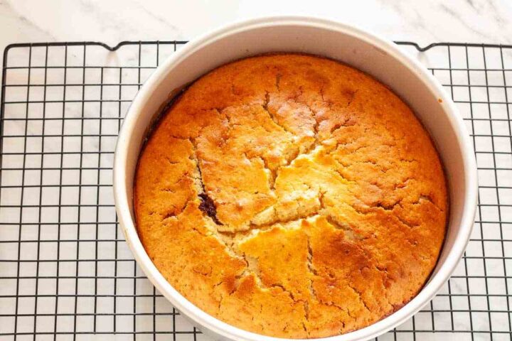 Freshly baked caramel peach upside-down cake cooling in the pan.