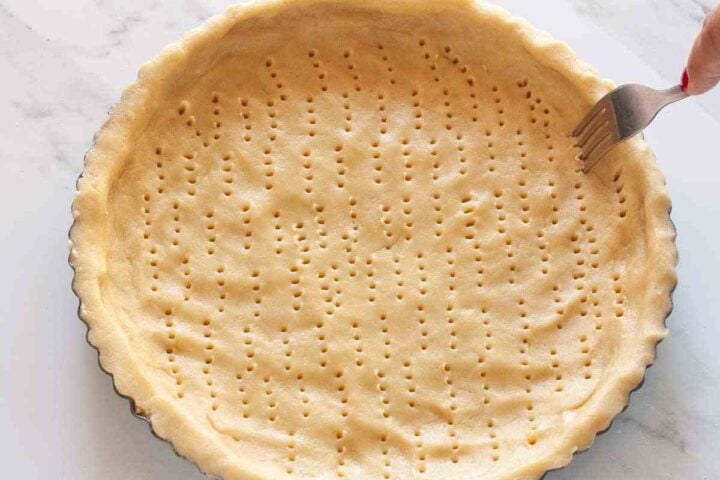 Pasta flora tart shell pressed into the pan and pricked with a fork.