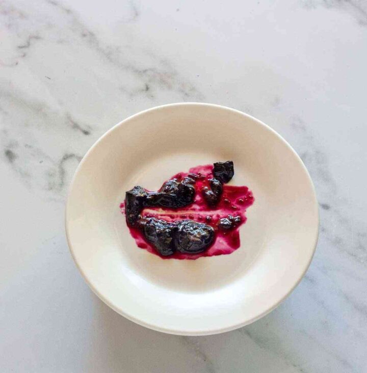 Cold plate test showing thickened blueberry jam that stays separated when drawn through.