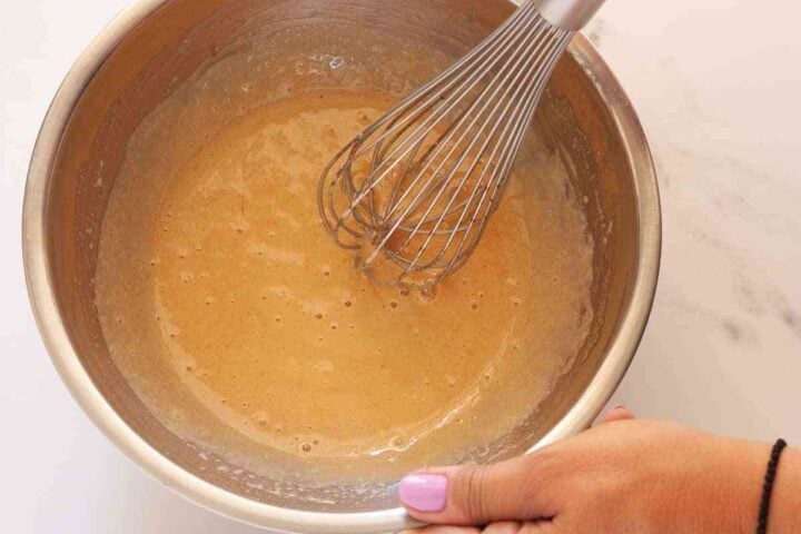 Egg, vanilla and sugars whisked until lighter, glossy, and slightly thickened.